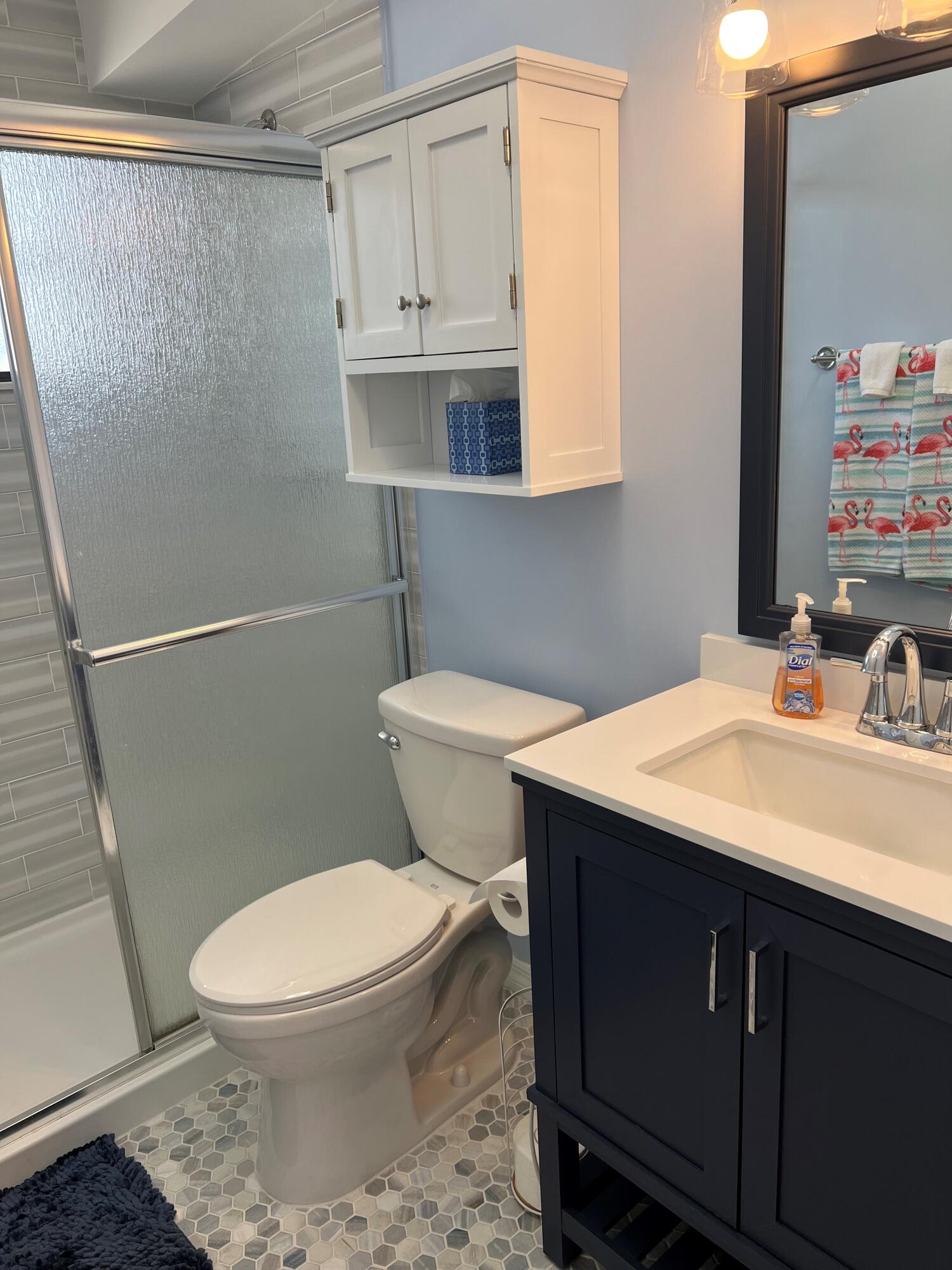 16 Shoreland Drive Key Largo, FL 33037 - Photo 8 of 16 a bathroom with a sink a toilet and a mirror