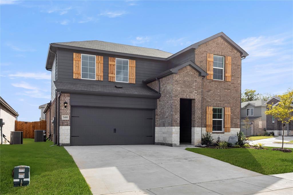a front view of a house with a yard and a garage
