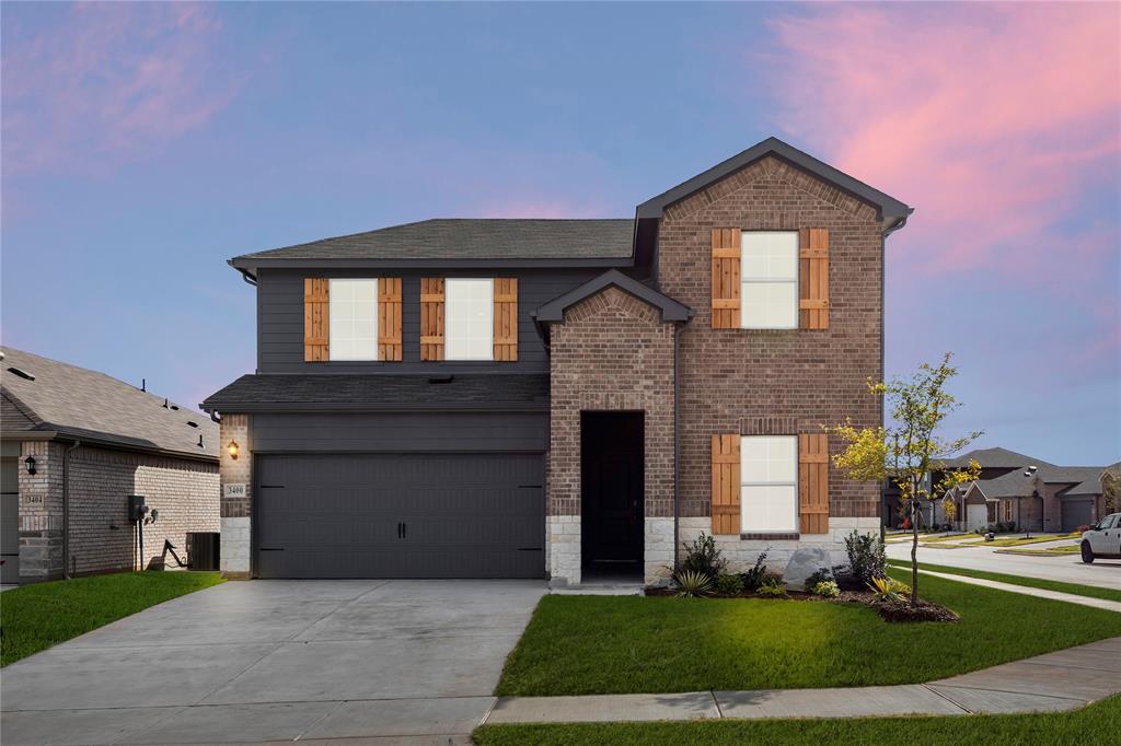 3400 Rendezvous Way Sherman, TX 75090 - Photo 2 of 17 a front view of a house with a yard and garage