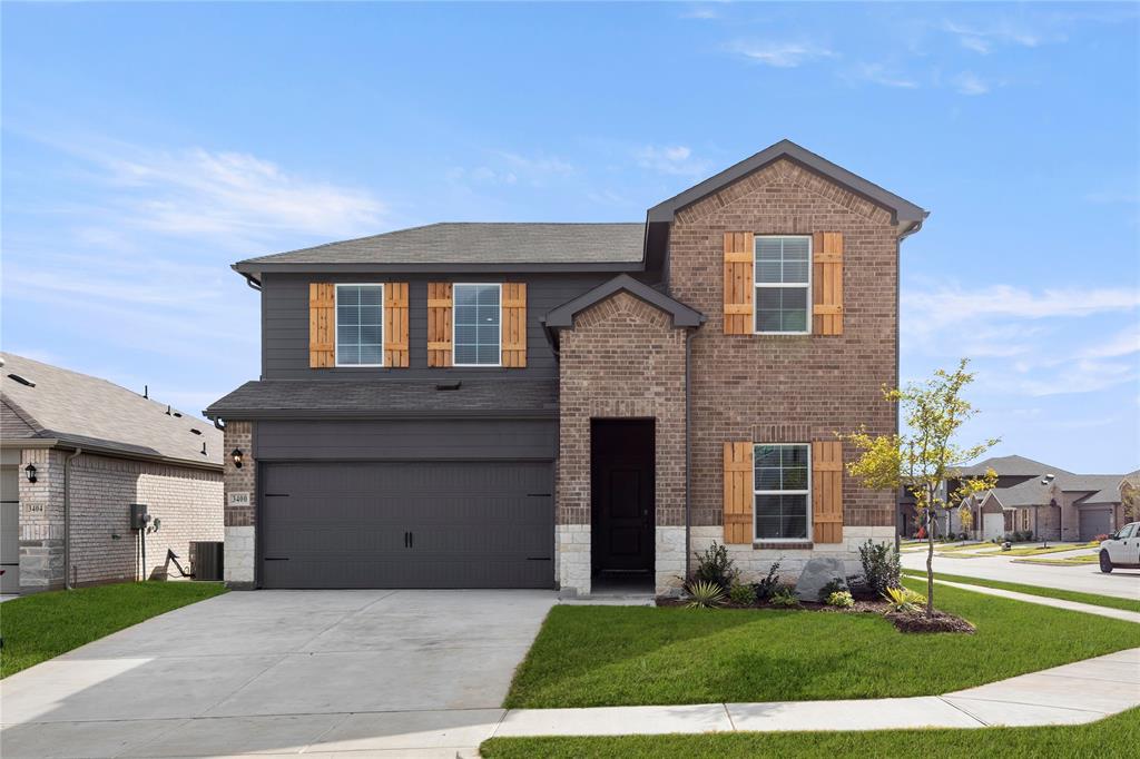 3400 Rendezvous Way Sherman, TX 75090 - Photo 3 of 17 a front view of a house with a yard and garage