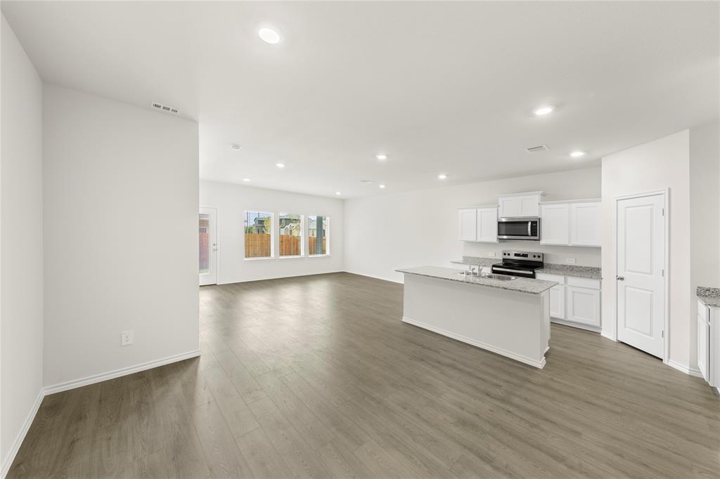 3400 Rendezvous Way Sherman, TX 75090 - Photo 17 of 17 a view of kitchen with kitchen island stainless steel appliances wooden floor and window