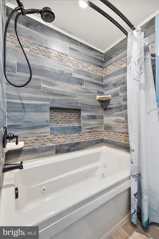 a view of a living room and workspace with furniture