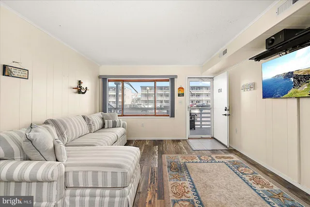 a living room with a bed furniture and a window