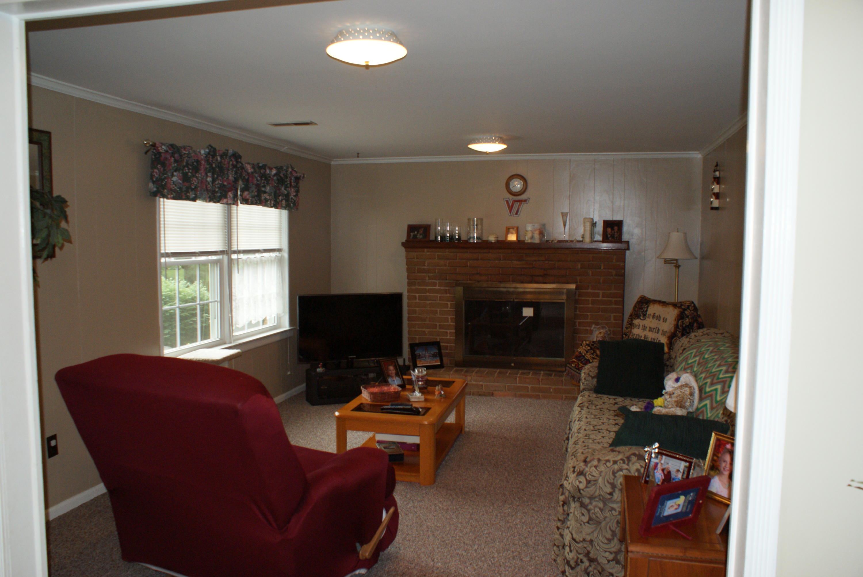 3630 Grandin Road Roanoke, VA 24018 - Photo 5 of 21 a living room with furniture a fireplace and a large window