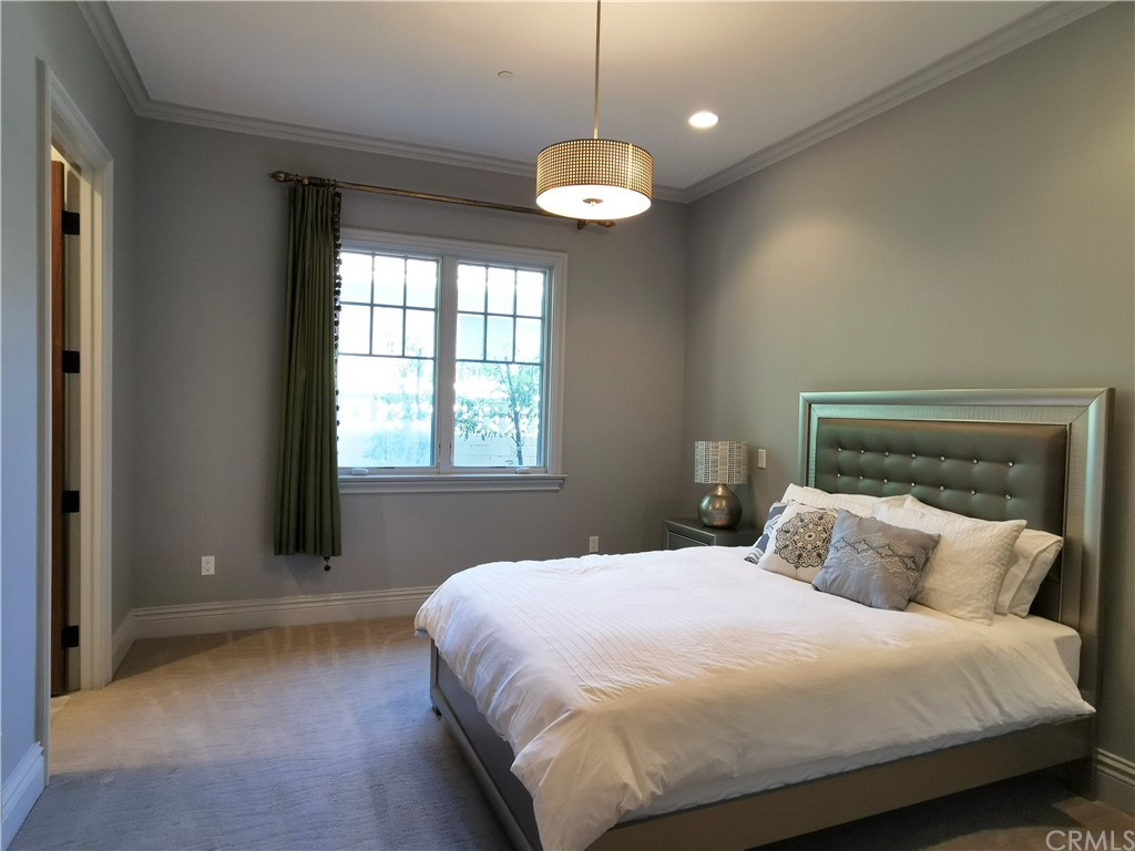 501 Cortez Road Arcadia, CA 91007 - Photo 11 of 15 a bedroom with a bed and a chandelier