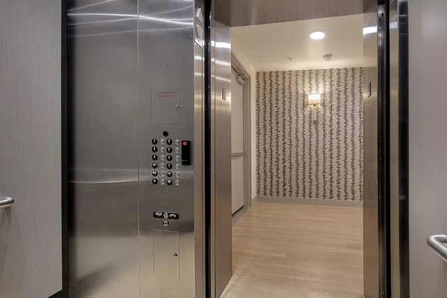 a bathroom with a glass door shower and a sink