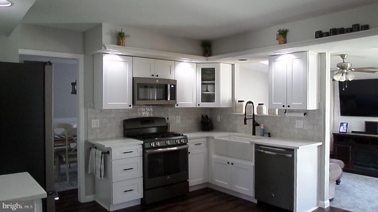 129 Country Lane Sicklerville, NJ 08081 - Photo 13 of 53 a kitchen with a sink stove and refrigerator