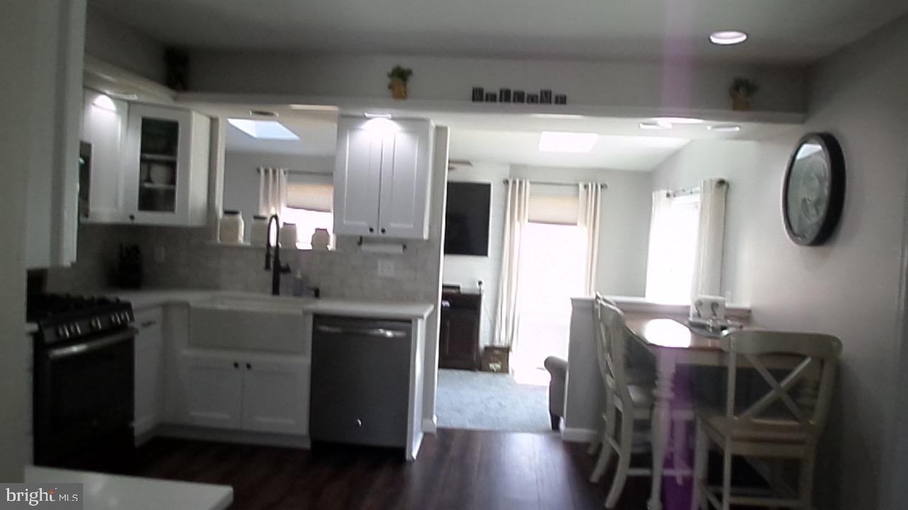 129 Country Lane Sicklerville, NJ 08081 - Photo 16 of 53 a kitchen with stainless steel appliances granite countertop a sink a stove and a refrigerator