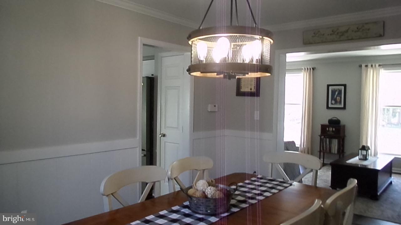 129 Country Lane Sicklerville, NJ 08081 - Photo 19 of 53 a room with a chandelier fan and windows