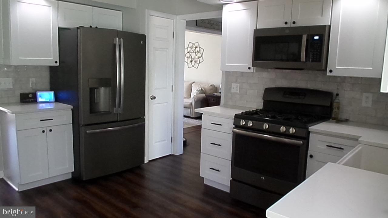 129 Country Lane Sicklerville, NJ 08081 - Photo 20 of 53 a kitchen with a refrigerator stove and microwave