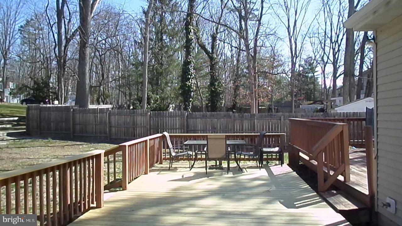 129 Country Lane Sicklerville, NJ 08081 - Photo 27 of 53 a view of a roof deck with table and chairs and wooden floor