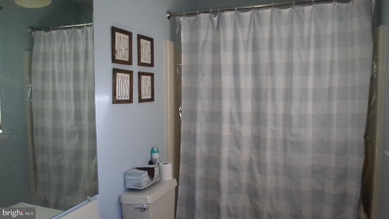 129 Country Lane Sicklerville, NJ 08081 - Photo 7 of 53 a bathroom with a shower curtain and toilet