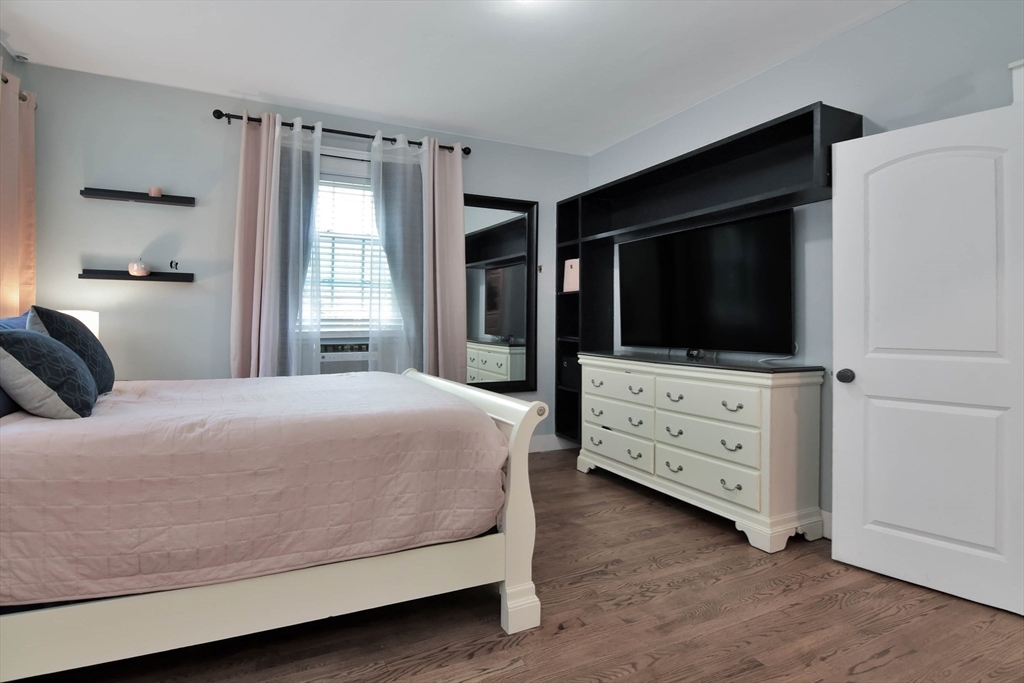 15 Balcomb Street Salem, MA 01970 - Photo 15 of 42 a bedroom with a bed and flat screen tv