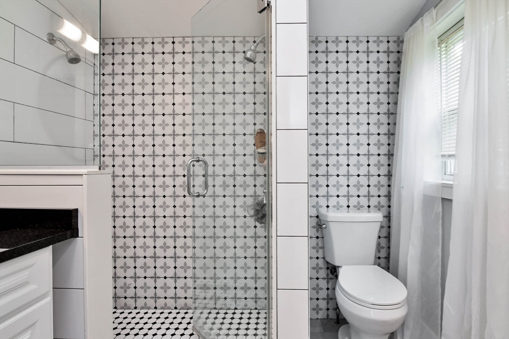 15 Balcomb Street Salem, MA 01970 - Photo 17 of 42 a a bathroom with a toilet and a shower curtain