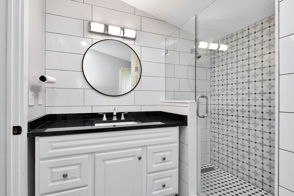 15 Balcomb Street Salem, MA 01970 - Photo 18 of 42 a bathroom with a sink a toilet and a mirror