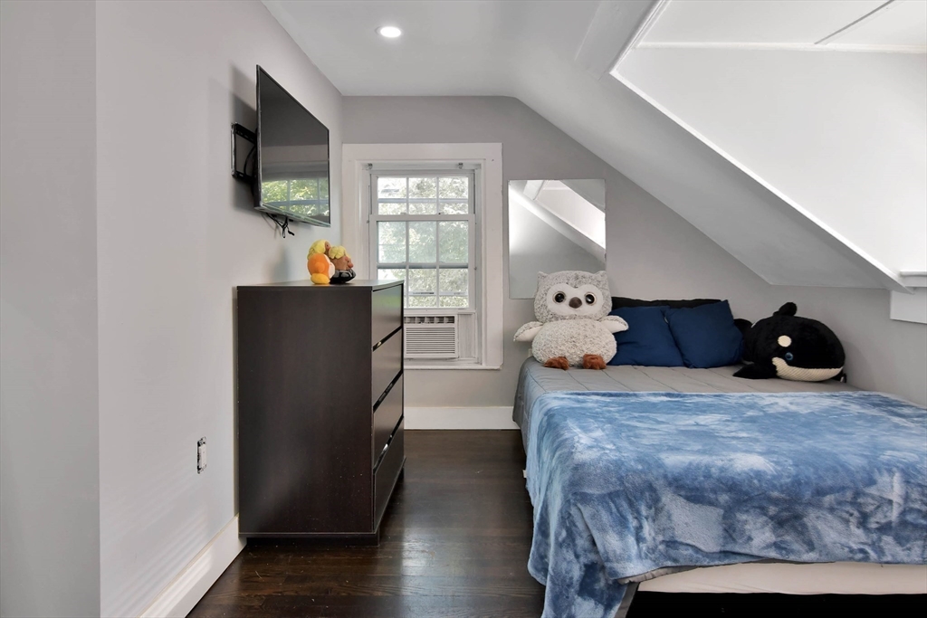 15 Balcomb Street Salem, MA 01970 - Photo 23 of 42 a bedroom with a bed and a flat screen tv