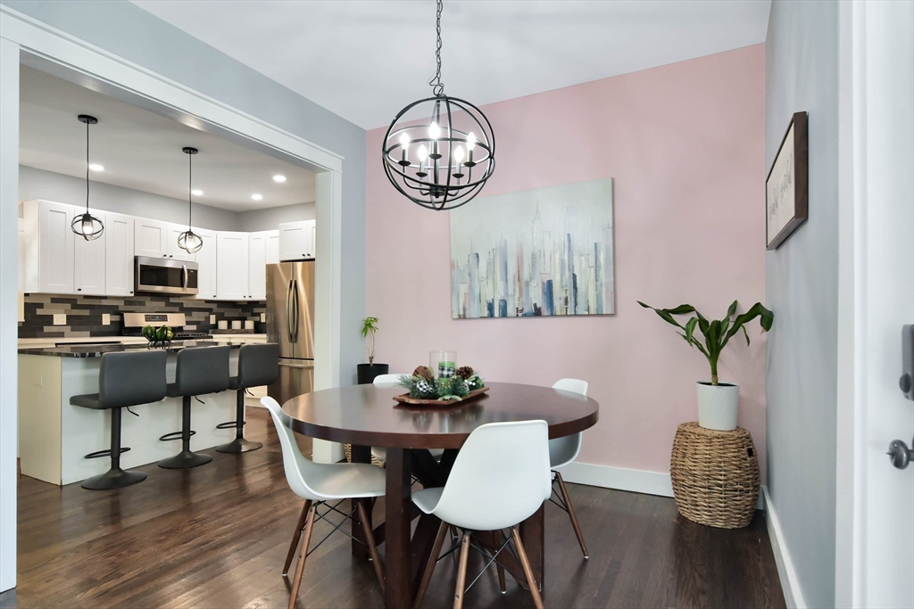 15 Balcomb Street Salem, MA 01970 - Photo 9 of 42 a view of a dining room with furniture wooden floor and a chandelier