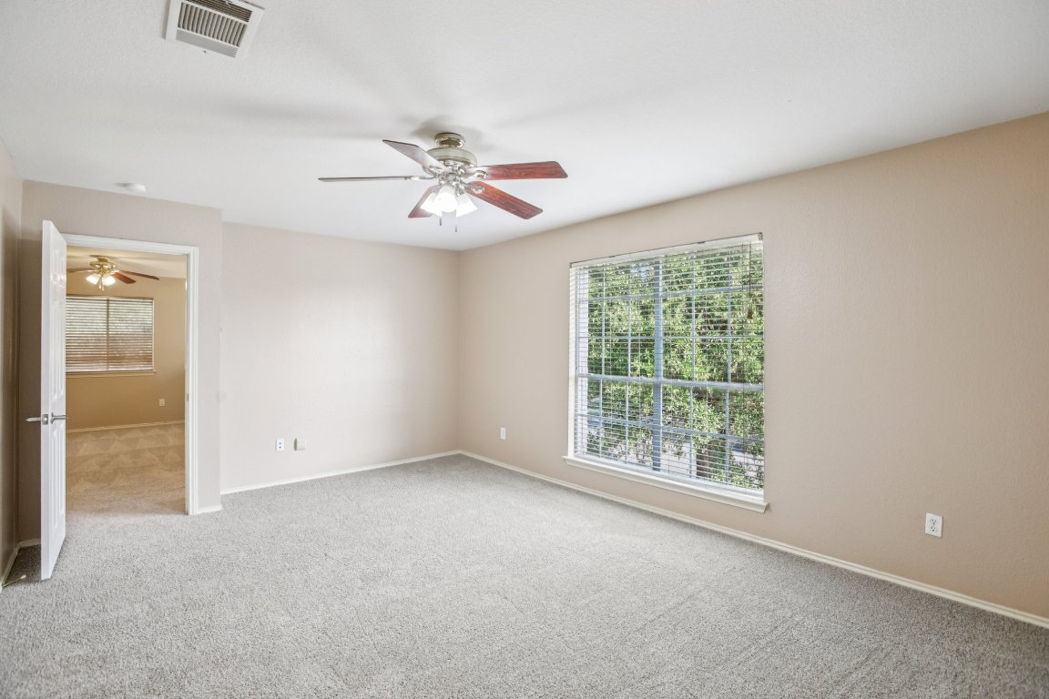 1132 Pine Portage Loop Leander, TX 78641 - Photo 19 of 39 an empty room with windows and fan