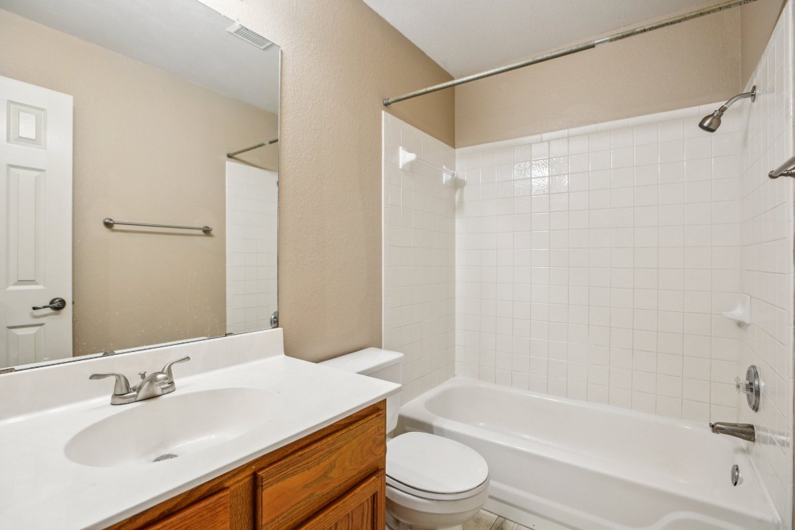1132 Pine Portage Loop Leander, TX 78641 - Photo 27 of 39 a bathroom with a sink a toilet and a bathtub