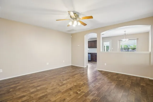 wooden floor in an empty room with a window