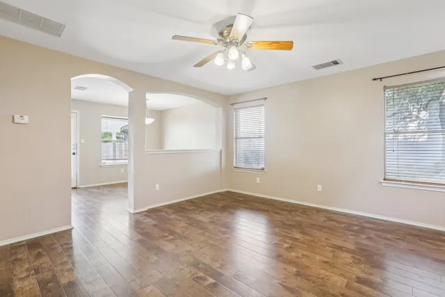 wooden floor in an empty room with a window