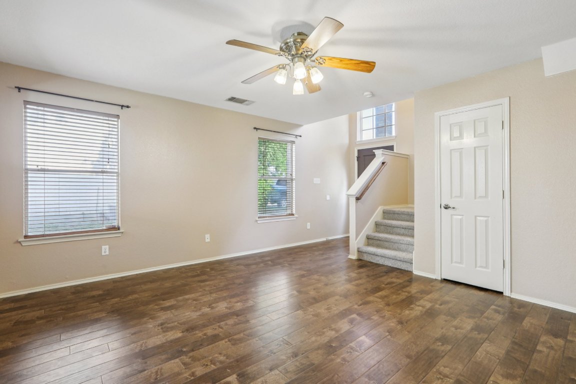 1132 Pine Portage Loop Leander, TX 78641 - Photo 5 of 39 wooden floor in an empty room with a window