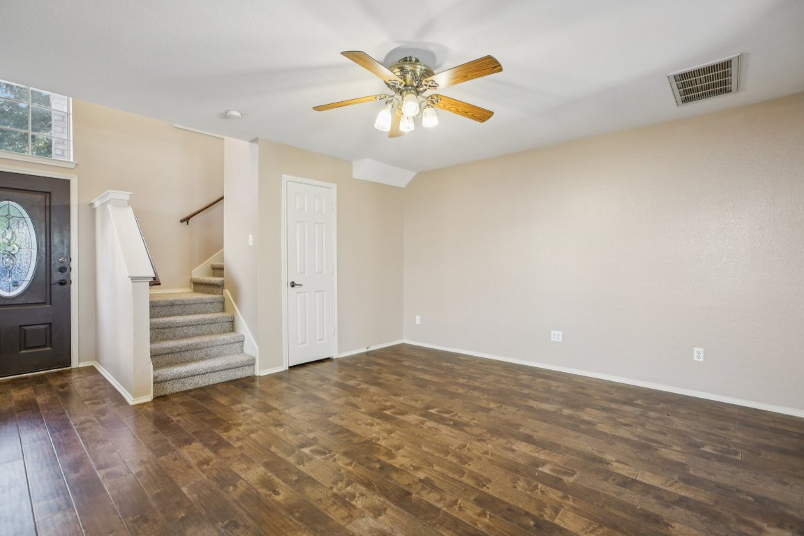 1132 Pine Portage Loop Leander, TX 78641 - Photo 6 of 39 wooden floor in an empty room with a ceiling fan