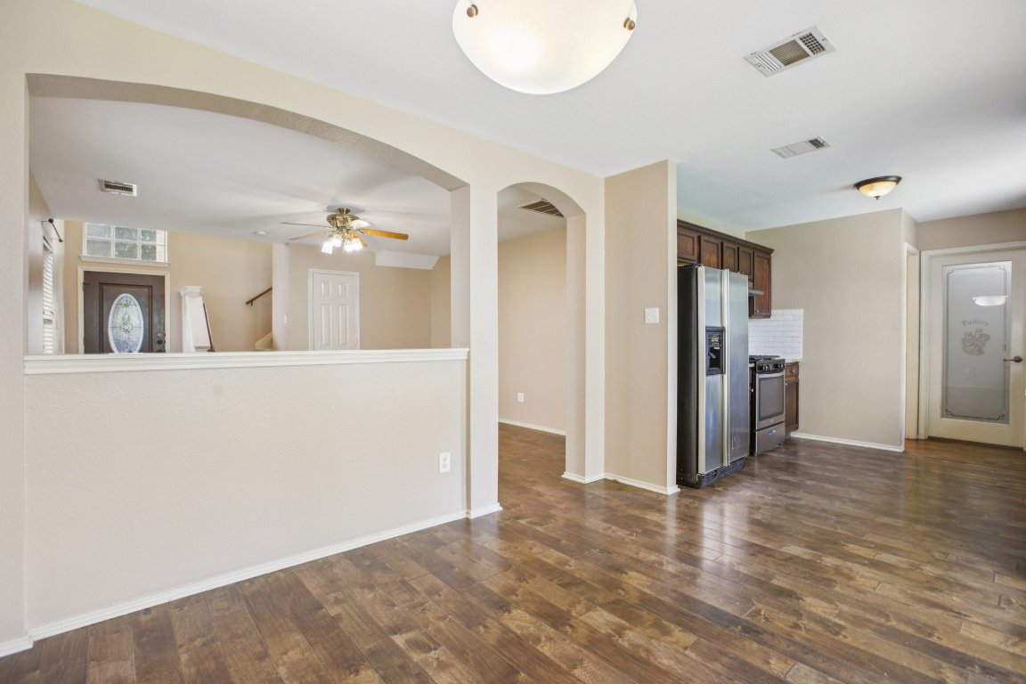1132 Pine Portage Loop Leander, TX 78641 - Photo 9 of 39 a view of a kitchen with a refrigerator a microwave and a sink
