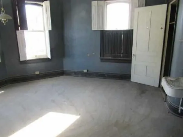 a view of an empty room and a window