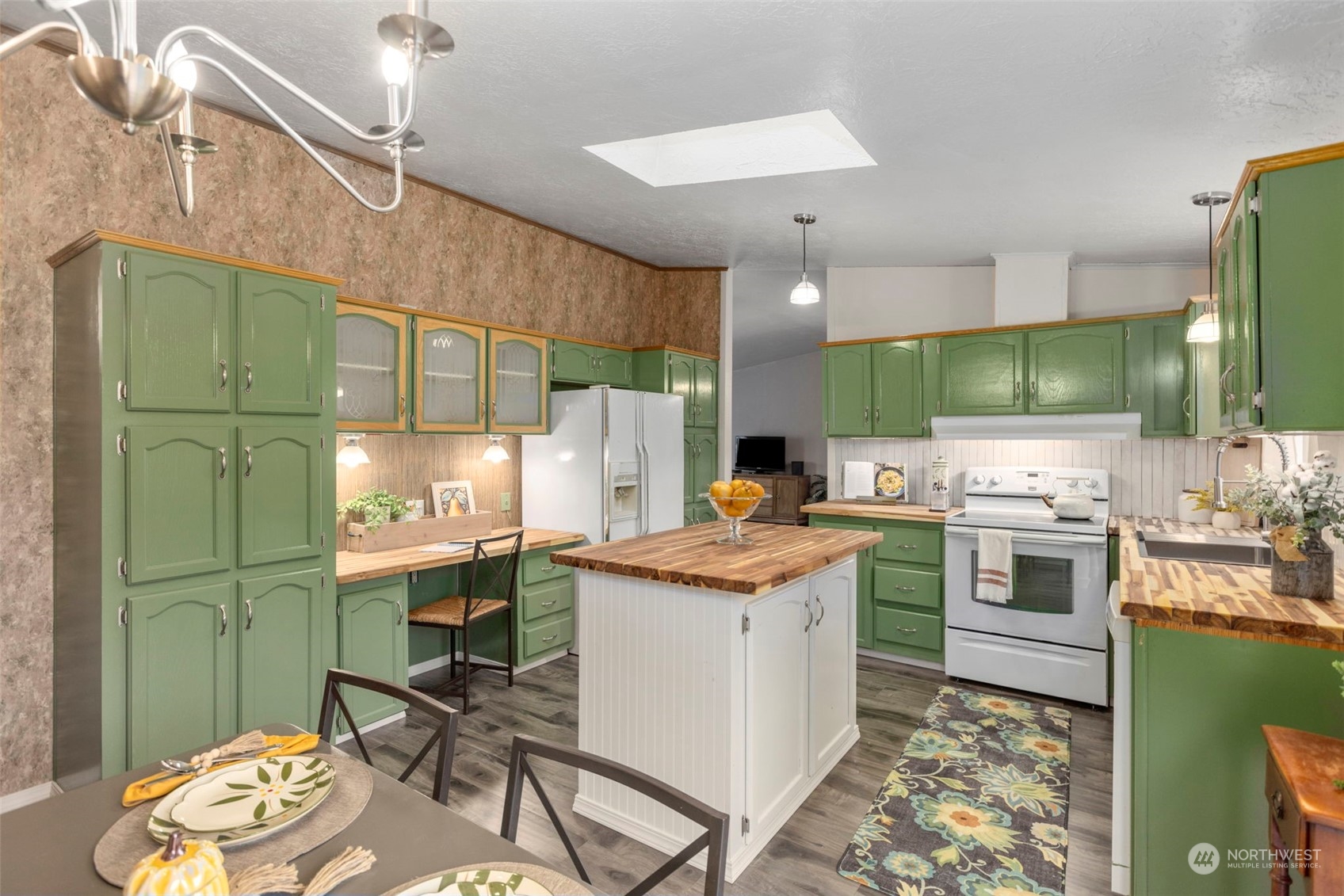 8638 173rd Avenue Southwest Rochester, WA 98579 - Photo 13 of 40 a kitchen with a sink a stove and chairs