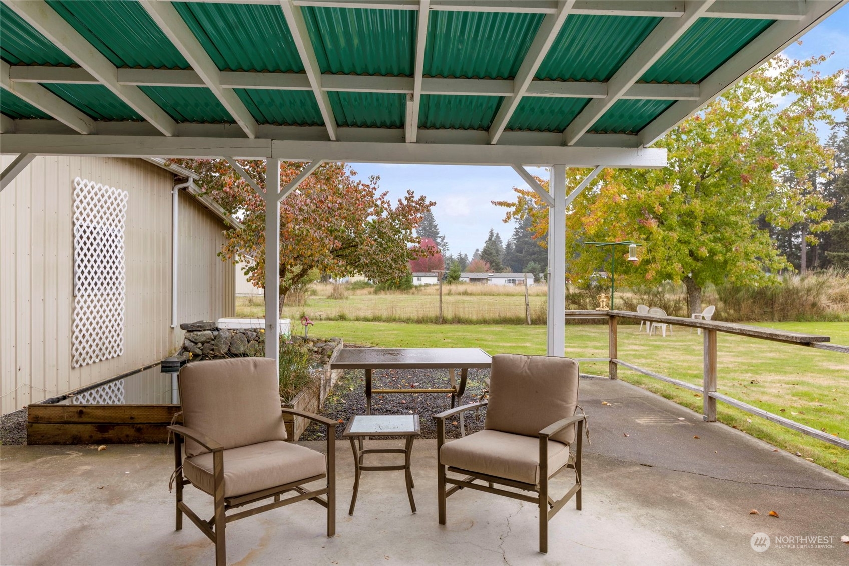 8638 173rd Avenue Southwest Rochester, WA 98579 - Photo 29 of 40 a view of a chairs and table in patio with a yard