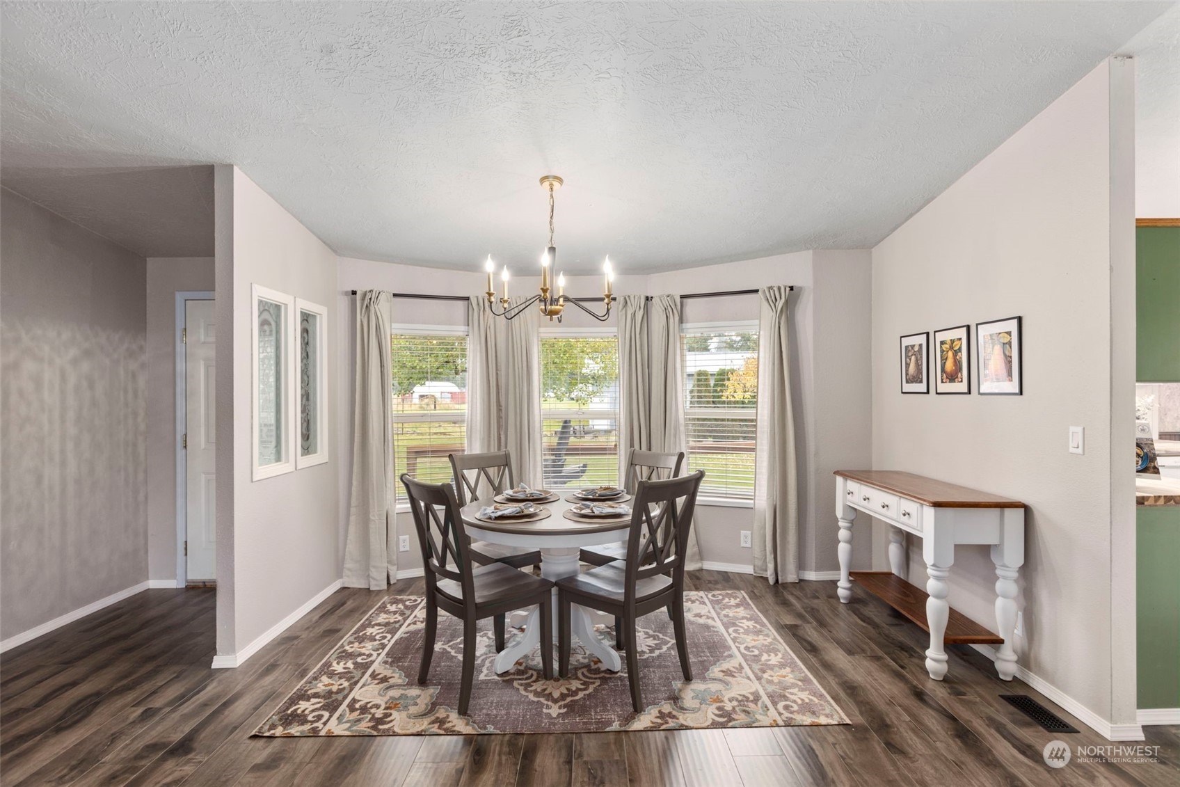 8638 173rd Avenue Southwest Rochester, WA 98579 - Photo 3 of 40 a view of a dining room with furniture window and wooden floor