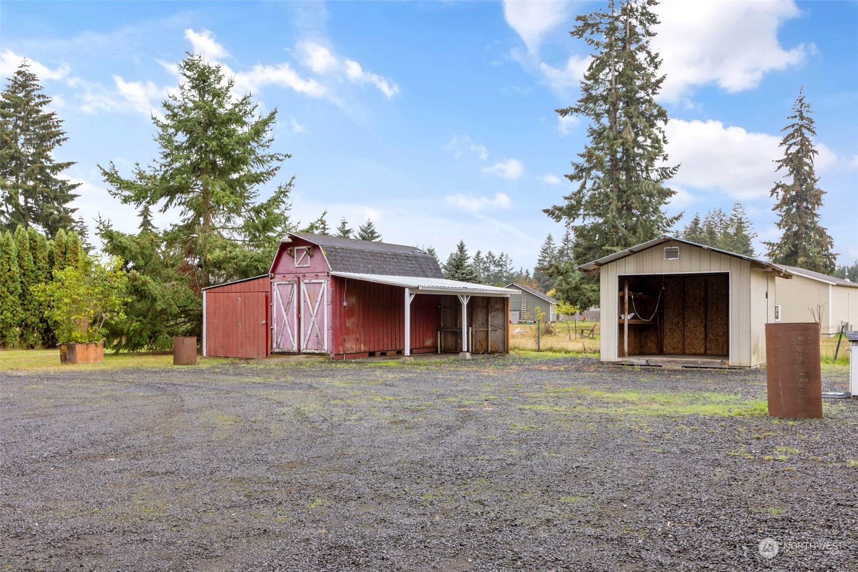 8638 173rd Avenue Southwest Rochester, WA 98579 - Photo 34 of 40 a view of a house with a yard and garage