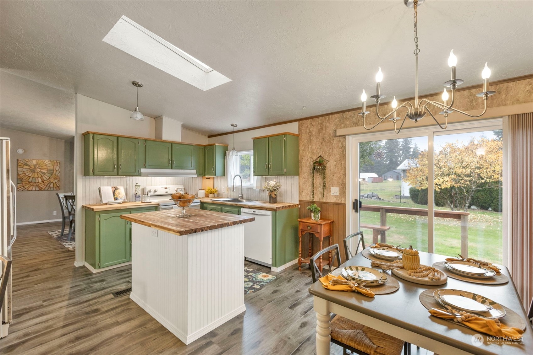 8638 173rd Avenue Southwest Rochester, WA 98579 - Photo 10 of 40 a kitchen with kitchen island a sink stove and wooden floor