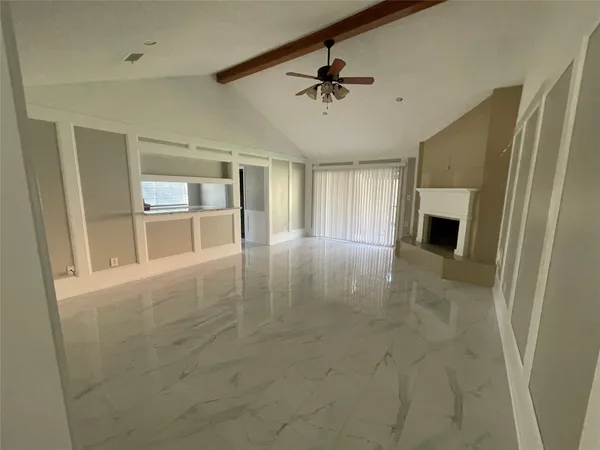 a view of an empty room with a fireplace