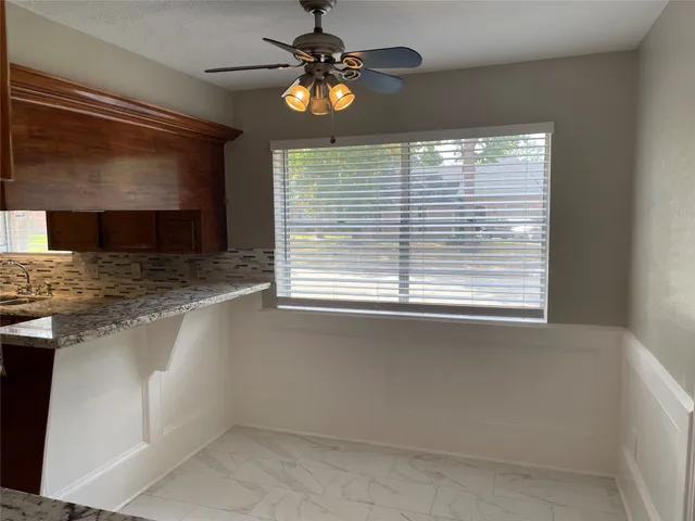 a view of empty room with window and fireplace