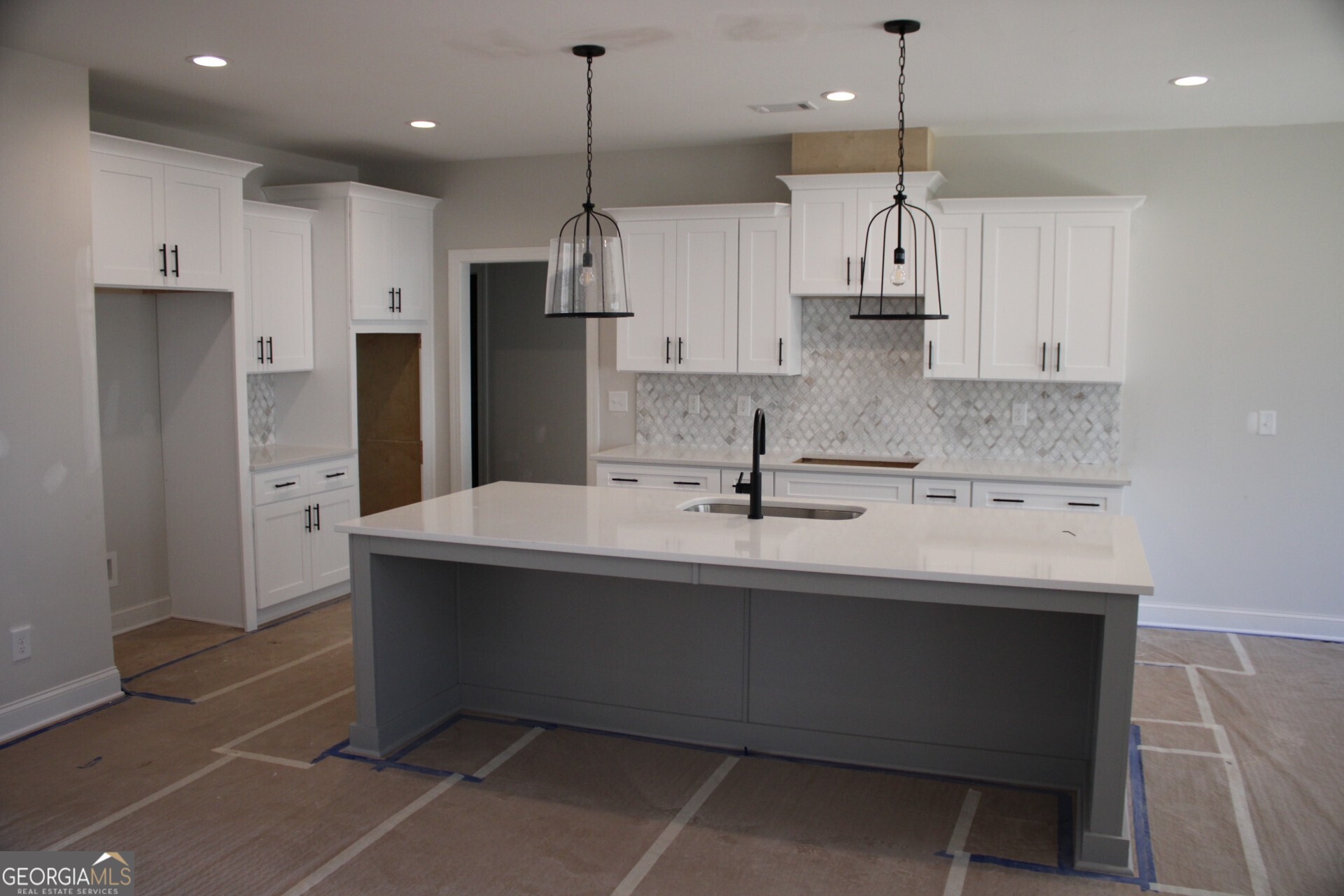 9536 Ephesus Church Road Villa Rica, GA 30180 - Photo 16 of 24 a kitchen with kitchen island a sink stainless steel appliances and cabinets