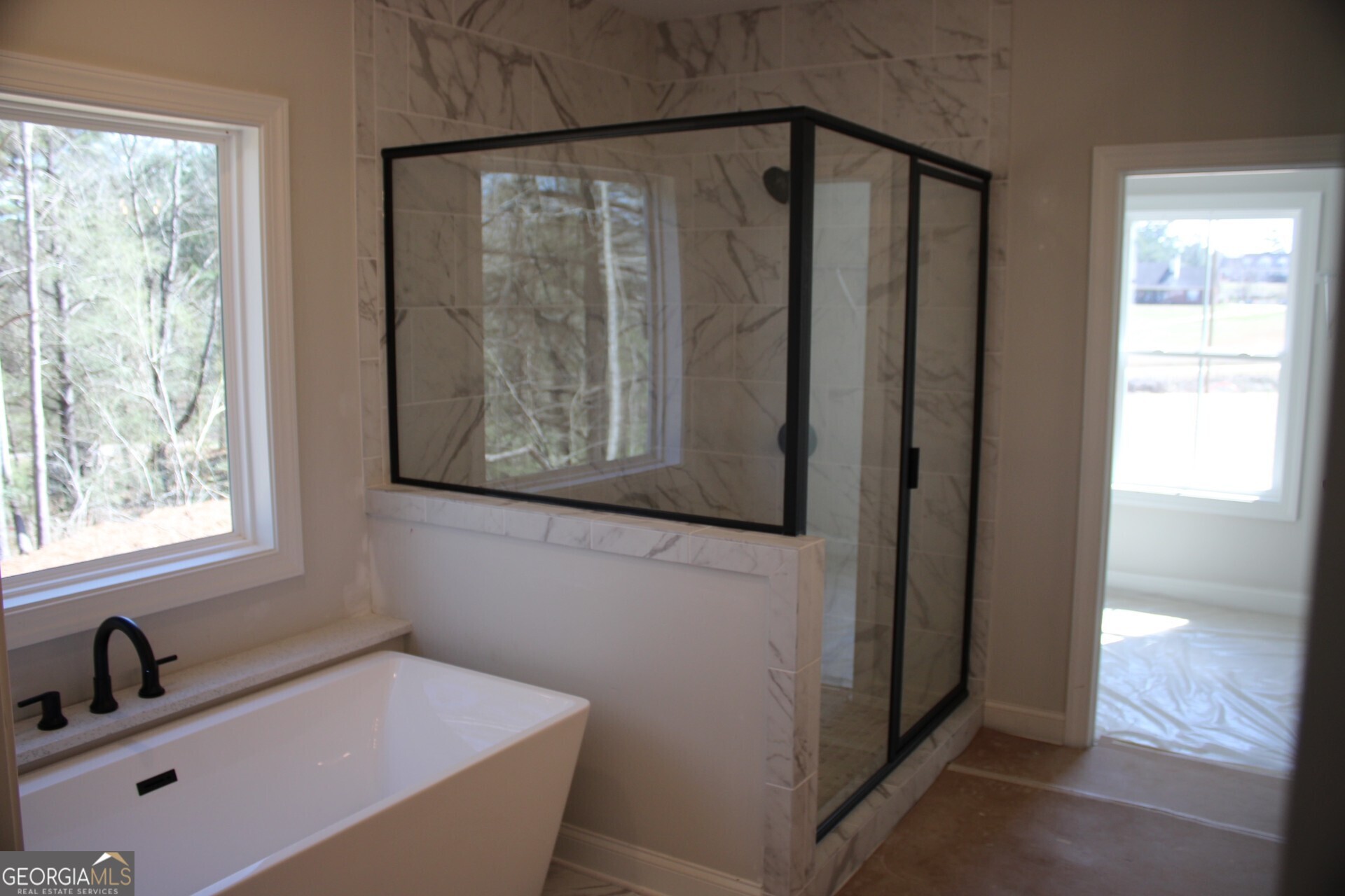 9536 Ephesus Church Road Villa Rica, GA 30180 - Photo 18 of 24 a bathroom with a bathtub and a window