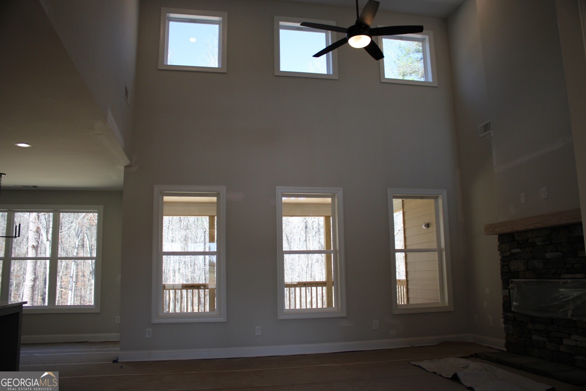 9536 Ephesus Church Road Villa Rica, GA 30180 - Photo 10 of 24 a view of an empty room with wooden floor and windows