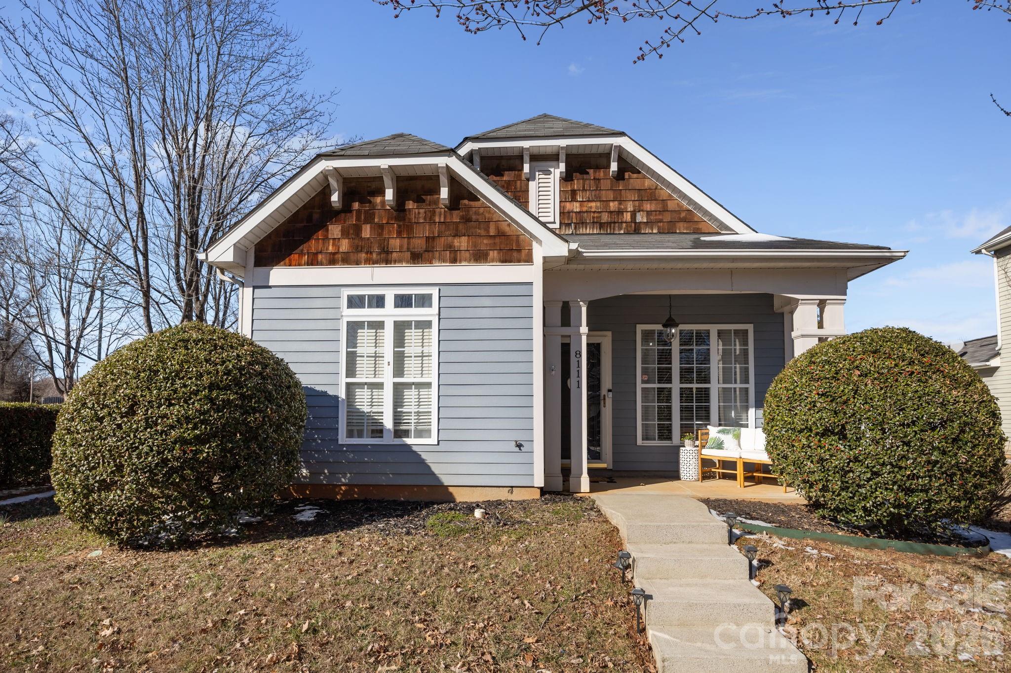 a front view of a house with a garden