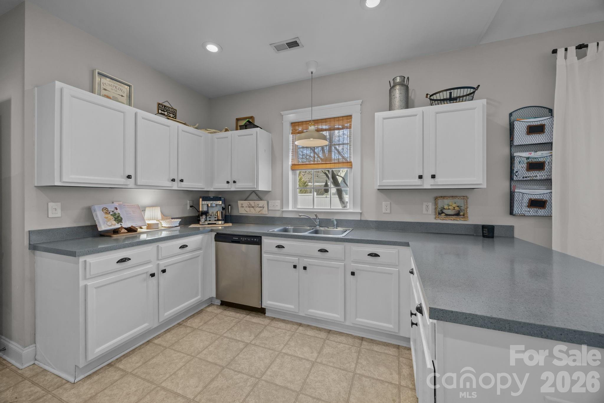 8111 Bud Henderson Road Huntersville, NC 28078 - Photo 11 of 39 a kitchen with stainless steel appliances granite countertop a sink and cabinets
