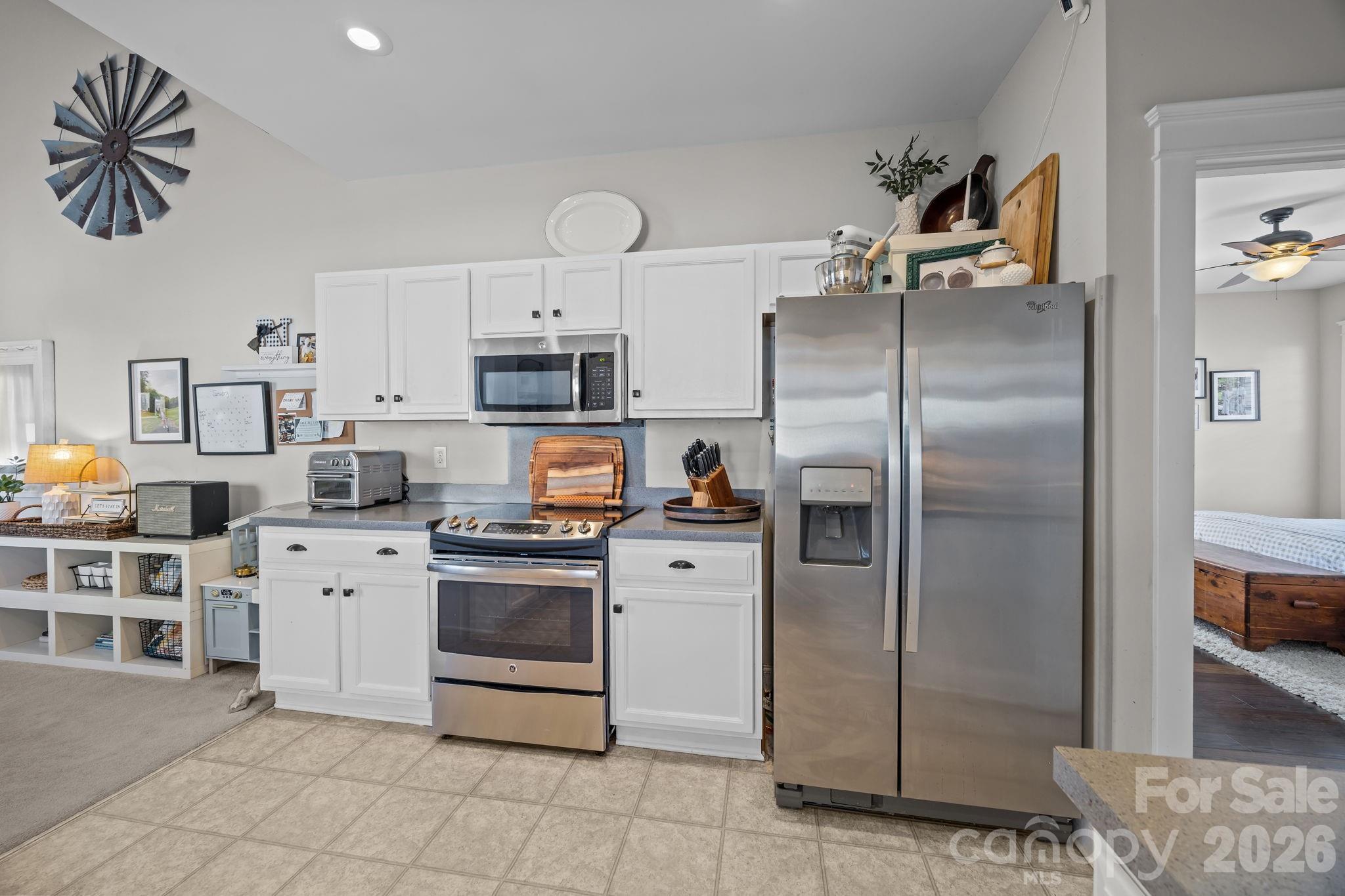 8111 Bud Henderson Road Huntersville, NC 28078 - Photo 16 of 39 a kitchen with stainless steel appliances a refrigerator sink and cabinets