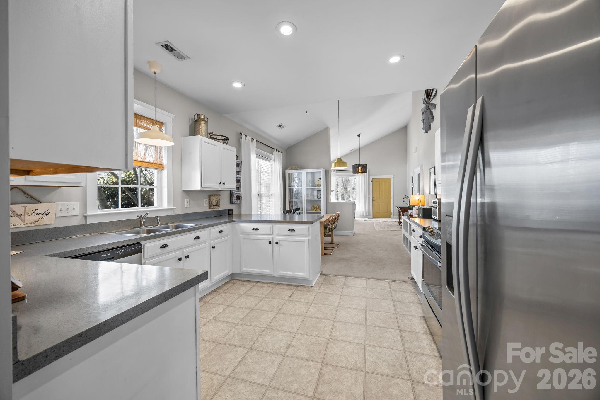 8111 Bud Henderson Road Huntersville, NC 28078 - Photo 17 of 39 a kitchen with stainless steel appliances a refrigerator sink and cabinets