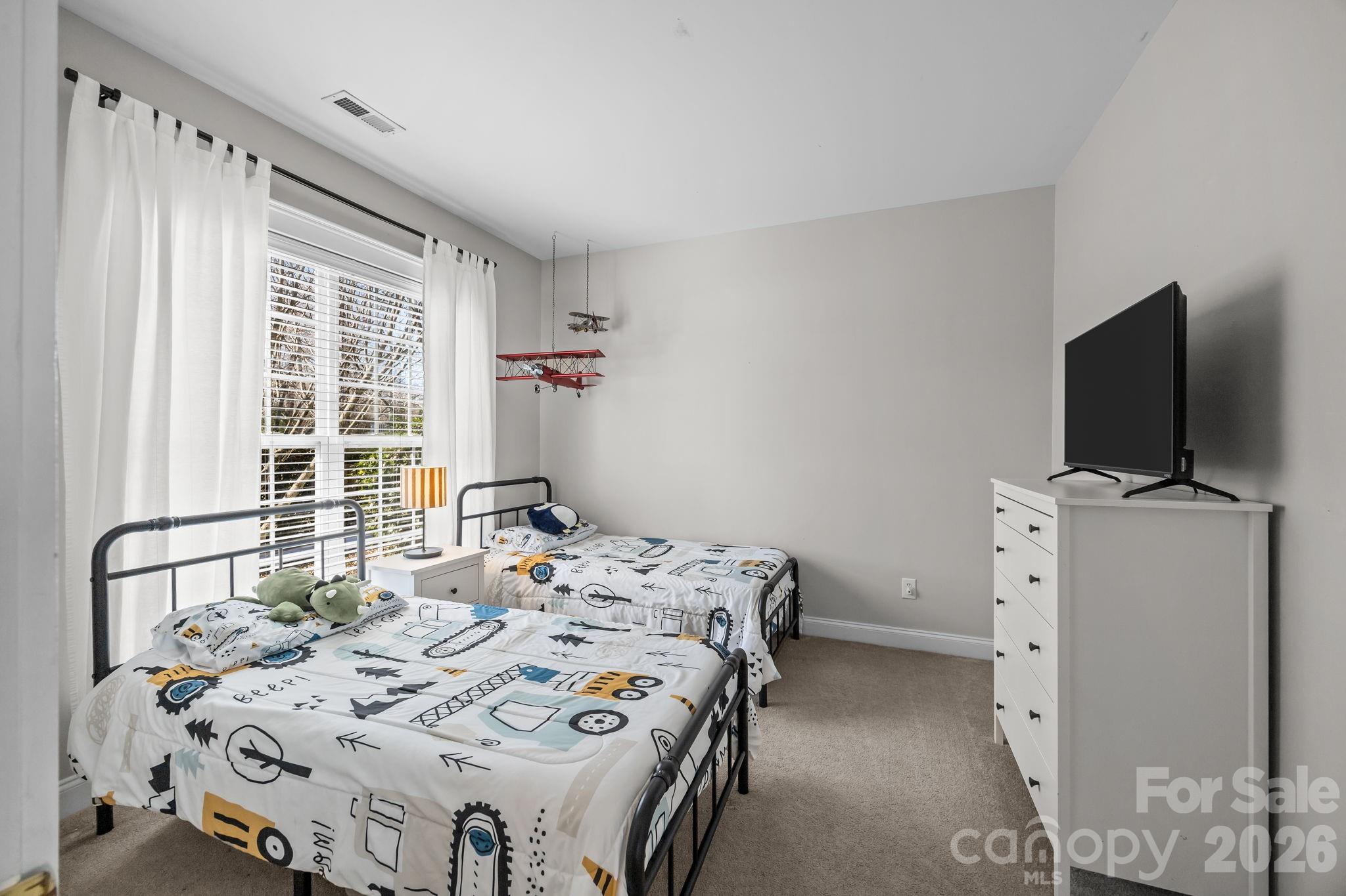 8111 Bud Henderson Road Huntersville, NC 28078 - Photo 22 of 39 a bedroom with a bed and a flat screen tv