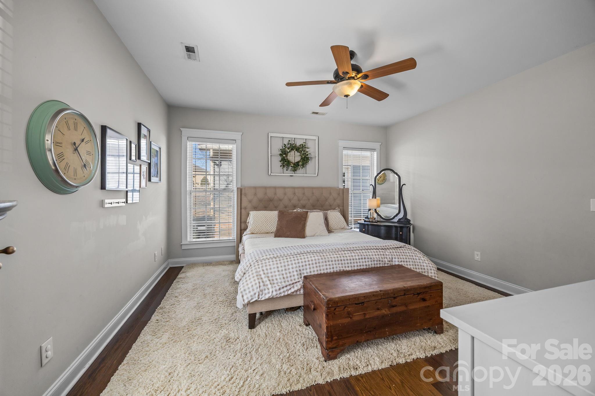 8111 Bud Henderson Road Huntersville, NC 28078 - Photo 24 of 39 a bedroom with a bed and a chandelier
