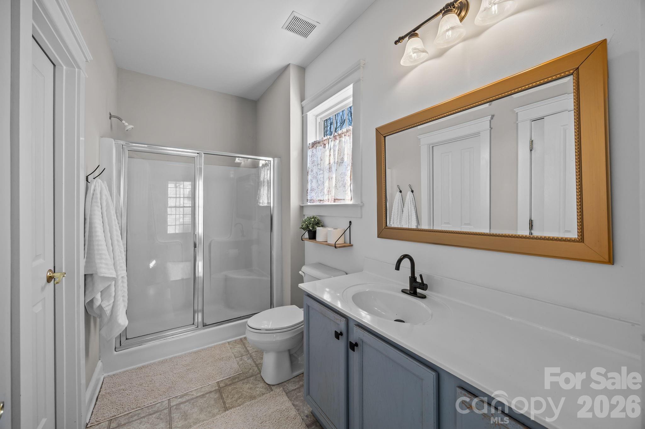 8111 Bud Henderson Road Huntersville, NC 28078 - Photo 25 of 39 a bathroom with a sink a toilet and shower