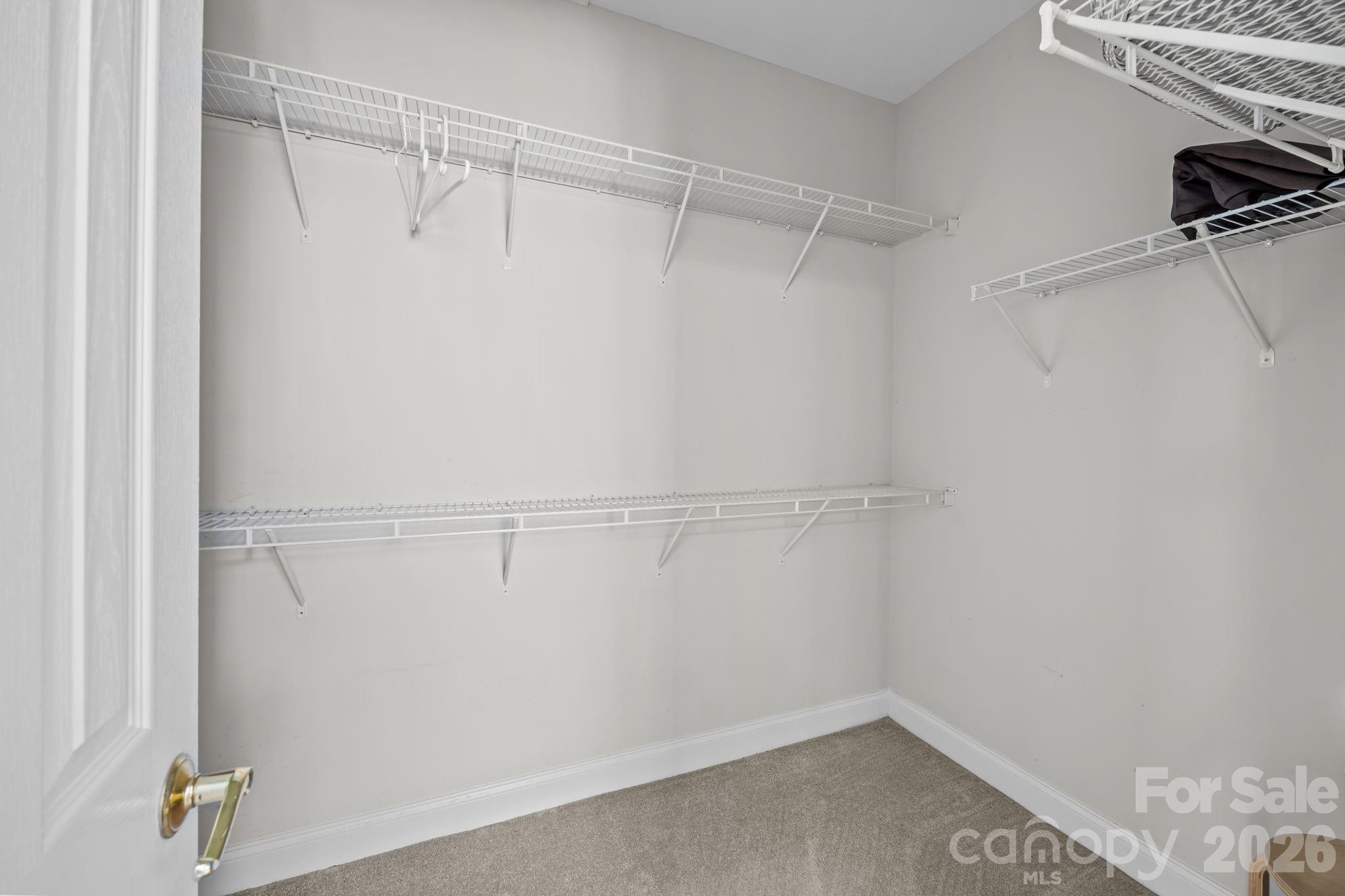 8111 Bud Henderson Road Huntersville, NC 28078 - Photo 26 of 39 a view of walk in closet with empty racks