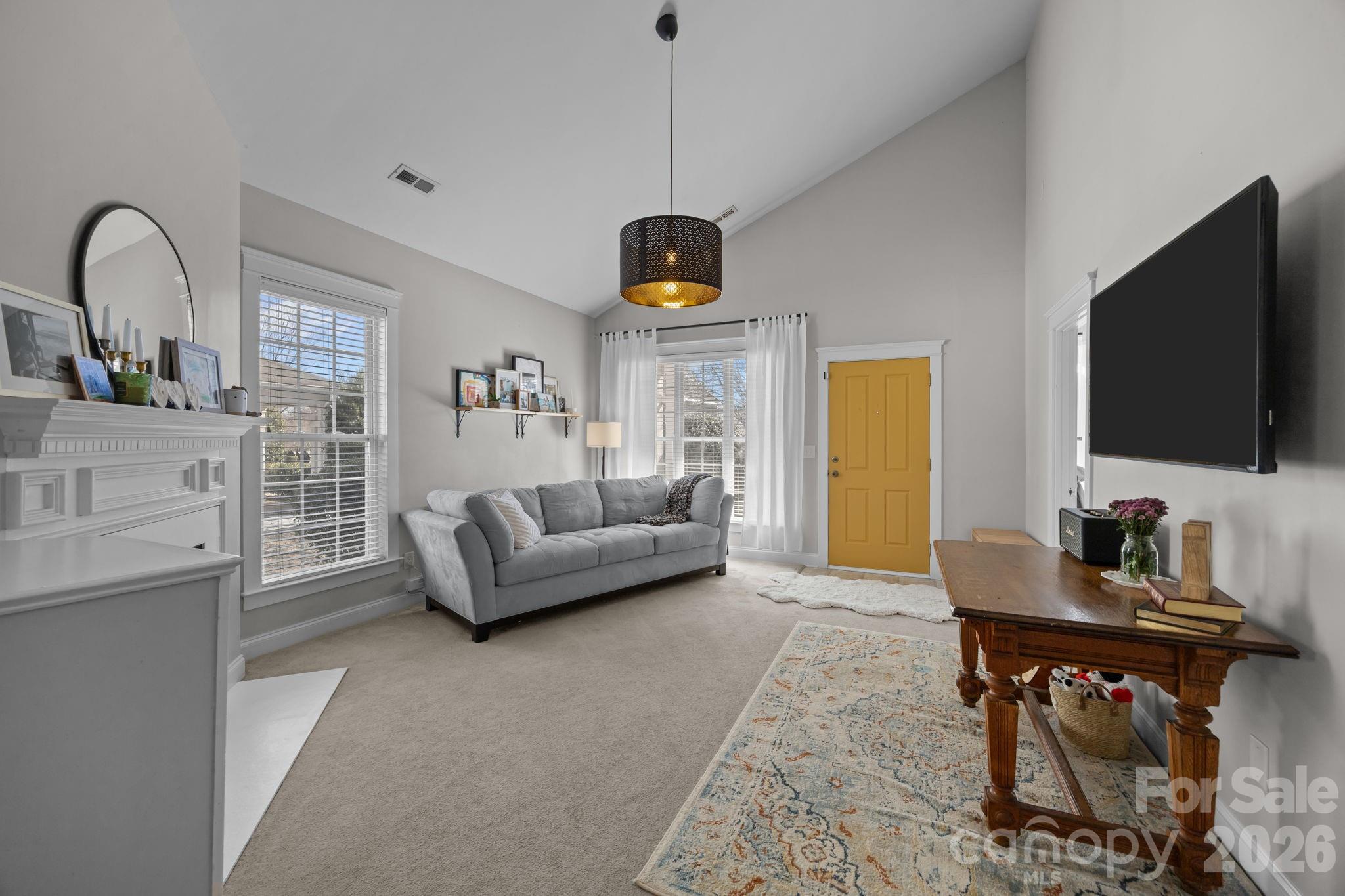 8111 Bud Henderson Road Huntersville, NC 28078 - Photo 5 of 39 a living room with furniture and a flat screen tv