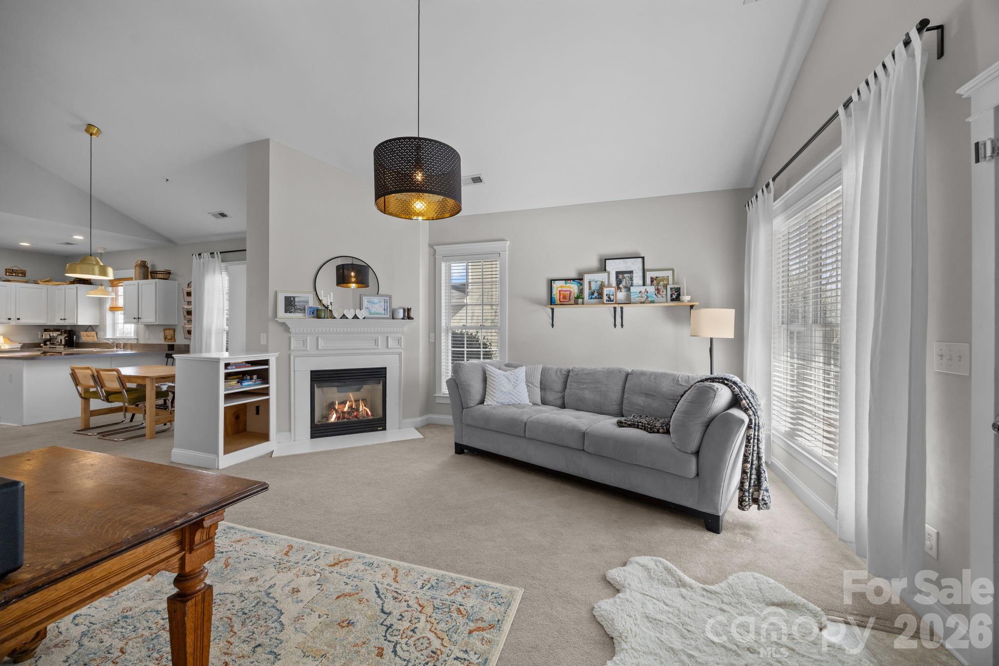 8111 Bud Henderson Road Huntersville, NC 28078 - Photo 6 of 39 a living room with furniture and a fireplace