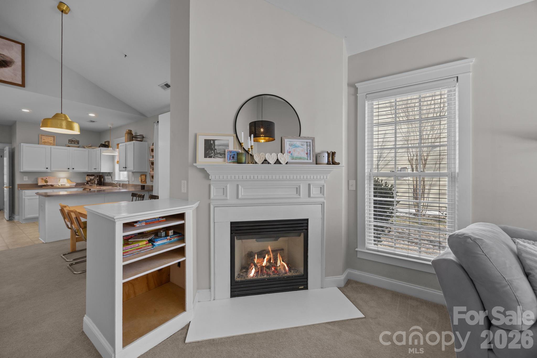 8111 Bud Henderson Road Huntersville, NC 28078 - Photo 7 of 39 a living room with furniture a fireplace and a window